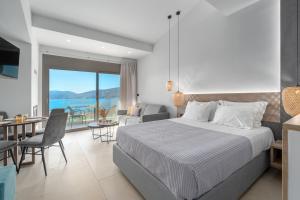 a bedroom with a bed and a living room at Harmony Apartments in Agioi Apostoli +138 photos