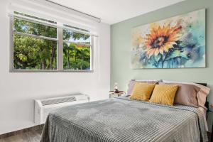 a bedroom with a bed and a painting on the wall at Costa Brava Condo by Otium in Ceiba