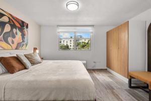 a bedroom with a large bed and a window at Costa Brava Condo by Otium in Ceiba