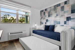 a bedroom with a bed and a window at Costa Brava Condo by Otium in Ceiba