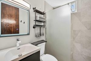 a bathroom with a sink and a toilet and a mirror at Costa Brava Condo by Otium in Ceiba +29 photos