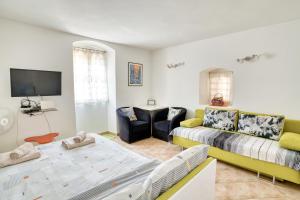 a living room with a couch and a tv and a table at Old Town Boskovic Apartment in Kotor