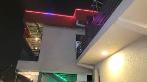 a building with a red light on the side of it at VEGAS Motel in Kigali