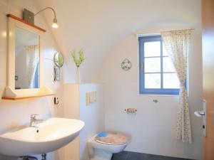 a bathroom with a sink and a toilet and a window at Fini in Am Schwarzen Busch