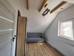 a room with a blue couch and a window at Domek NAD RZEKA in Korczew +19 photos
