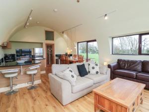 a living room with a couch and a table at The Rookery in Greenfield Cross Roads