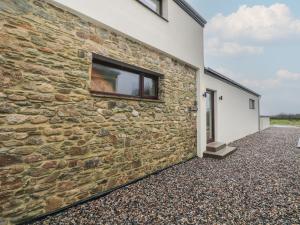 a stone wall with a window on the side of a building at The Rookery in Greenfield Cross Roads