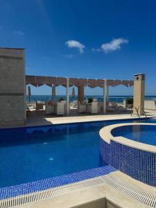 a swimming pool with a view of the ocean at SF Apartments Lux in Dobra Voda