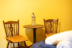 a table and two chairs with a bottle on top of it at The Sheepshead Guesthouse in Durrus
