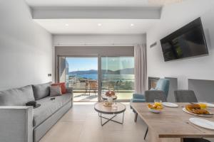 a living room with a couch and a table at Harmony Apartments in Agioi Apostoli