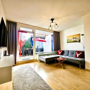 a living room with a couch and a table at Ferienwohnung Panoramablick in Füssen