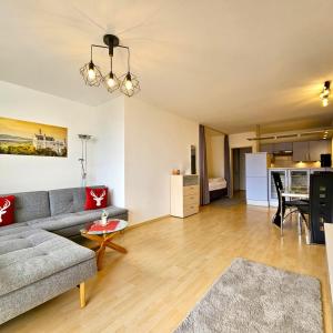 a living room with a couch and a table at Ferienwohnung Panoramablick in Füssen