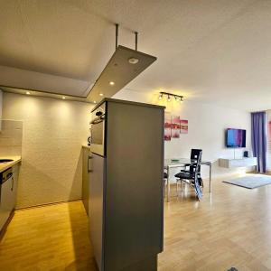 a kitchen and living room with a table and a refrigerator at Ferienwohnung Panoramablick in Füssen +17 photos