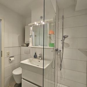 a white bathroom with a sink and a shower at Ferienwohnung Panoramablick in Füssen
