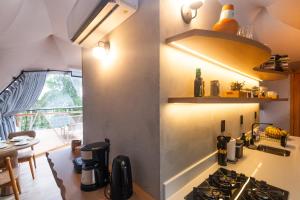 a kitchen with a stove top oven next to a table at Refúgio Bela Cabanas in Imaruí +41 photos