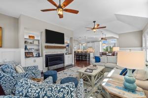 a living room with blue and white furniture at 4919 - The Leonardo in Kitty Hawk