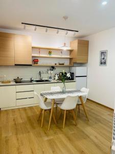 a kitchen with a dining room table and chairs at Holidays inkutaisi in Tsqnetʼi +16 photos