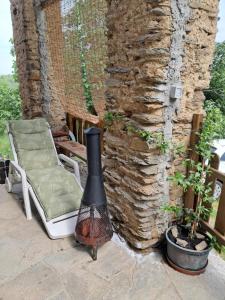 a fireplace on a patio next to a stone wall at Rifugio Felice in Bagnolo Piemonte +16 photos