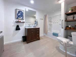 a bathroom with a sink and a shower and a toilet at Wilder Bunkhouse in De Smet
