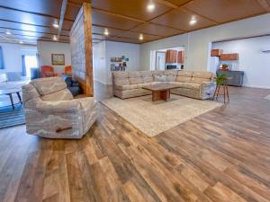 a large living room with two couches and a table at Wilder Bunkhouse in De Smet