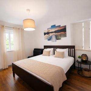 a bedroom with a large bed in a room at Cascais Little Garden Rooms Old Town in Cascais
