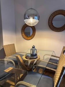 a dining room with a glass table and chairs at SIENA stan na dan Doboj in Doboj