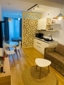 a living room with a couch and a table at Holidays inkutaisi in Tsqnetʼi