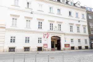 a large white building on a city street at DATRI Petite Suite 4 in Vienna