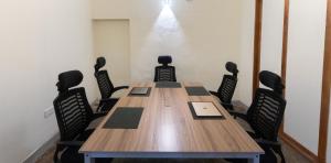 a conference room with a long wooden table and chairs at Surfing Elephant in Matara +106 photos
