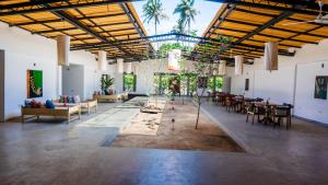 a large room with tables and chairs in it at Surfing Elephant in Matara