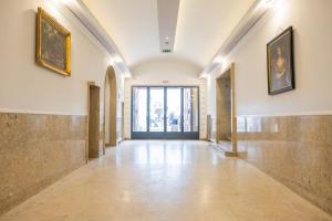 an empty hallway with paintings on the walls at DATRI Petite Suite 4 in Vienna +6 photos
