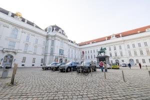 a large building with cars parked in a courtyard at DATRI Petite Suite 4 in Vienna