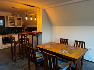 a kitchen with a wooden table and chairs at Kuća Sunny Rudnik in Rudnik