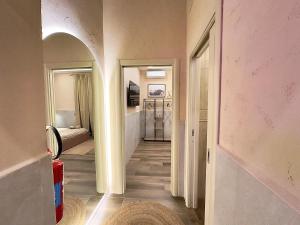 a hallway with a hallway leading to a bedroom at Falco Deluxe Home - Naples Airport & Town in Naples