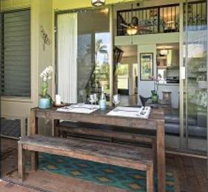 a wooden table with a bench in a room at Turtle Bay Kuilima Collection 6 West in Kahuku