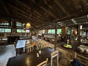 a dining room with tables and chairs in a building at Capricho Asturiano in Santo Antônio do Leite