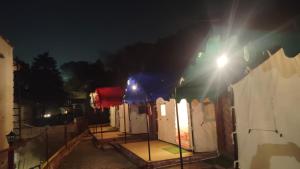 a row of toilets on a fence at night at Charming Lake View Camp in Bhīm Tāl