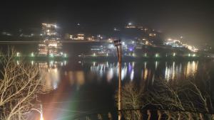 a view of a city at night with a body of water at Charming Lake View Camp in Bhīm Tāl