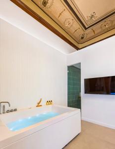 a bath tub in a bathroom with a ceiling at Themis Toledo - Private Spa Apartment in Naples +21 photos