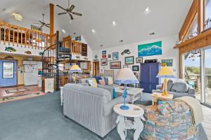 a living room with couches and a staircase at 7828 - Swing Belly's Roost in Frisco