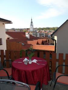 a dining room table with a balcony overlooking a city at Hotel Joseph 1699 in Třebíč