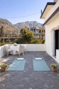 a patio with a table and blue yoga mats at Namya Villas in Bhīm Tāl
