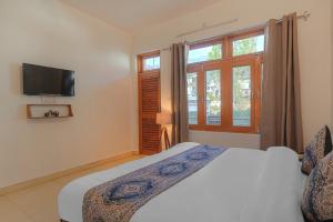 a bedroom with a bed and a tv on the wall at Bir Downtown in Bīr +9 photos