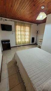 a bedroom with a large bed and a wooden ceiling at Hotel Casa Grande in Pareditas