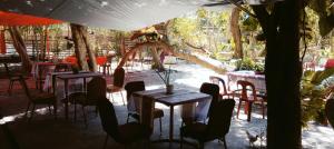 a group of tables and chairs in a restaurant at JUNGLE GYM LA UNION Prana fan kubo 2 pax in Rimus