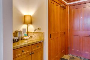 a kitchen with a counter and a table with a lamp at Everline Resort Studio w/ Luxury Resort Perks in Olympic Valley