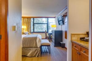 a hotel room with a bed and a dining room at Everline Resort Studio w/ Luxury Resort Perks in Olympic Valley +28 photos