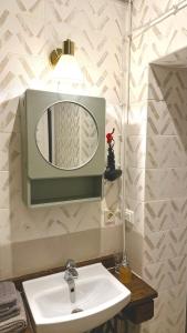 a bathroom with a sink and a mirror on the wall at Bright Cozy Apartment in Riga Quiet Center in Riga +10 photos