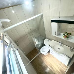 a small bathroom with a toilet and a sink at Blue 52 in Torres