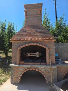 a brick oven with a fire inside of it at Vila Sopot lux in Risti°i